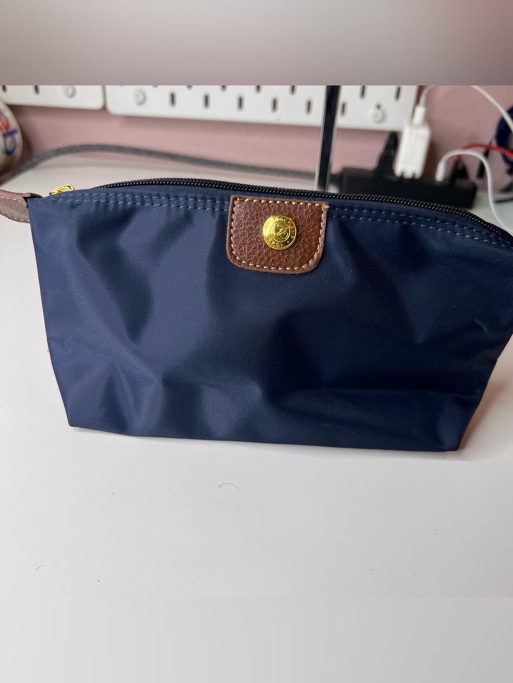 Longchamp Le Pliage Original pouch features a signature gold-toned snap button